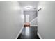 Inviting hallway with sleek, black floors leading to the staircase at 3111 W De Leon St # 2, Tampa, FL 33609