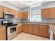 A view of the kitchen featuring stainless steel appliances, tile floors and stone countertops at 3111 W De Leon St # 2, Tampa, FL 33609