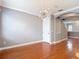 Open-concept living room featuring hardwood floors, crown molding, and arched doorway at 3111 W De Leon St # 2, Tampa, FL 33609