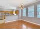 Open-concept living room features hardwood floors, crown molding, and sightlines to kitchen at 3111 W De Leon St # 2, Tampa, FL 33609