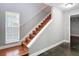 A wood staircase featuring a white railing and a window providing ample natural light at 3111 W De Leon St # 2, Tampa, FL 33609