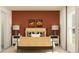 Cozy bedroom with desert-inspired decor, offering a warm and inviting ambiance with side tables and lamps at 32066 Griffin Sands Ln, San Antonio, FL 33576