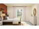 Bright bedroom featuring neutral tones, modern furniture, and a large window with sheer curtains at 32066 Griffin Sands Ln, San Antonio, FL 33576