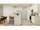 Open concept kitchen showcasing white cabinets, modern appliances, a breakfast bar, and stylish light fixtures at 32066 Griffin Sands Ln, San Antonio, FL 33576