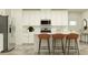 Modern kitchen featuring stainless steel appliances, a breakfast bar with seating, and ample counter space at 32066 Griffin Sands Ln, San Antonio, FL 33576
