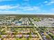Aerial view showcases residential neighborhood and distant horizon at 3209 Meta Ct, Largo, FL 33771