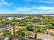 Aerial view features homes, commercial building, mature trees and landscaping at 3209 Meta Ct, Largo, FL 33771