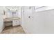 White-tiled bathroom with a tiled shower, and a vanity with countertop and sink at 3209 Meta Ct, Largo, FL 33771