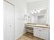 Bright bathroom featuring a vanity with white cabinets and countertop with sink and large mirror at 3209 Meta Ct, Largo, FL 33771