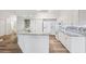 Bright kitchen with granite countertops, white cabinets, modern appliances, and wood floors at 3209 Meta Ct, Largo, FL 33771