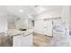 Bright kitchen with granite countertops, white cabinets, modern appliances, and wood floors at 3209 Meta Ct, Largo, FL 33771