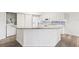 Bright kitchen with granite countertops, white cabinets, modern appliances, and wood floors at 3209 Meta Ct, Largo, FL 33771