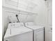 A laundry room with a white washer and dryer, and white wire rack shelving at 3209 Meta Ct, Largo, FL 33771