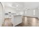 Open-concept kitchen with granite countertops, white cabinets, and stainless steel appliances flowing into the living space at 3209 Meta Ct, Largo, FL 33771