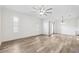Open living room with lots of natural light, hardwood floors, and ceiling fan at 3209 Meta Ct, Largo, FL 33771