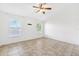The main bedroom features neutral walls, tile flooring, a ceiling fan and lots of natural light at 3209 Meta Ct, Largo, FL 33771