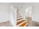 Bright staircase with hardwood steps and white risers leads to the upper level at 3209 Meta Ct, Largo, FL 33771