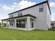 Wide angle view of the backyard with a large covered patio at 3483 Yellow Leaf Cir, Spring Hill, FL 34609