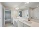 Spacious bathroom with dual sinks, granite countertop, large mirror, and tile flooring at 3483 Yellow Leaf Cir, Spring Hill, FL 34609