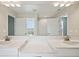 Bathroom featuring dual sinks, granite countertop, large mirror, and updated fixtures at 3483 Yellow Leaf Cir, Spring Hill, FL 34609