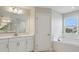 Well-lit bathroom featuring double sinks, a soaking tub, and modern fixtures, perfect for relaxation at 3483 Yellow Leaf Cir, Spring Hill, FL 34609