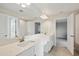 Bright bathroom with dual sinks, granite countertop, large mirror, and tile flooring at 3483 Yellow Leaf Cir, Spring Hill, FL 34609