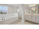 Luxurious bathroom with a separate shower, soaking tub, double sinks, and high-end finishes for a spa-like experience at 3483 Yellow Leaf Cir, Spring Hill, FL 34609
