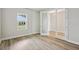 Bright bedroom features light wood flooring, a large window and an open doorway at 3483 Yellow Leaf Cir, Spring Hill, FL 34609