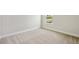 Bright bedroom with neutral carpet, white trim, and a window view at 3483 Yellow Leaf Cir, Spring Hill, FL 34609