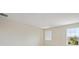 Bright and airy carpeted bedroom with a neutral color palette and two large windows overlooking the neighborhood at 3483 Yellow Leaf Cir, Spring Hill, FL 34609