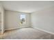 A bright bedroom featuring neutral carpet, a window, and white trim at 3483 Yellow Leaf Cir, Spring Hill, FL 34609