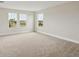 Bright carpeted bedroom featuring three large windows offering a lovely outdoor view and natural light at 3483 Yellow Leaf Cir, Spring Hill, FL 34609