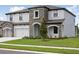 Charming two-story home with a manicured lawn and stone accents at 3483 Yellow Leaf Cir, Spring Hill, FL 34609