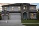 Charming two-story home with a manicured lawn and stone accents at 3483 Yellow Leaf Cir, Spring Hill, FL 34609