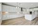 Bright kitchen with white cabinets, stainless steel appliances, and hardwood floors at 3483 Yellow Leaf Cir, Spring Hill, FL 34609