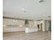 Spacious open kitchen with large island, white cabinets, and stainless steel hood at 3483 Yellow Leaf Cir, Spring Hill, FL 34609