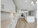 Modern kitchen features stainless steel appliances, white cabinets, a center island, and sleek hardware at 3483 Yellow Leaf Cir, Spring Hill, FL 34609