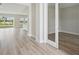 Open-concept living room with hardwood floors, recessed lighting, and glass sliding doors to outdoor space at 3483 Yellow Leaf Cir, Spring Hill, FL 34609