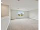 Upstairs open living room with bright natural light and neutral carpet at 3483 Yellow Leaf Cir, Spring Hill, FL 34609