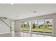 Bright living room featuring sliding glass doors with a view of the backyard at 3483 Yellow Leaf Cir, Spring Hill, FL 34609