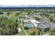 Stunning aerial view of the golf course, community pools, and tennis court at 3504 Wedge Way, New Port Richey, FL 34655