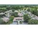 Expansive aerial view showcasing the property's proximity to lush greenery, a golf course, and community amenities at 3504 Wedge Way, New Port Richey, FL 34655