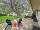 Relaxing backyard patio with seating and an umbrella under a large mature oak tree at 3504 Wedge Way, New Port Richey, FL 34655