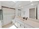 Clean bathroom featuring a skylight, shower/tub combination, and a large vanity at 3504 Wedge Way, New Port Richey, FL 34655