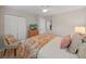 Comfortable bedroom with ceiling fan, television, and wooden dresser and closet at 3504 Wedge Way, New Port Richey, FL 34655