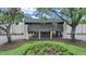 A shaded building exterior showcasing covered parking and well-kept grounds, framed by mature trees at 3504 Wedge Way, New Port Richey, FL 34655