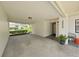 Covered carport showcasing lighting, house number, and decorative landscaping near the front door at 3504 Wedge Way, New Port Richey, FL 34655