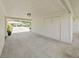 Attached carport with storage space, and view of driveway and neighboring house at 3504 Wedge Way, New Port Richey, FL 34655