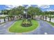 An inviting view of the clubhouse entrance with manicured landscaping and palm trees, creating a welcoming atmosphere at 3504 Wedge Way, New Port Richey, FL 34655