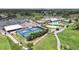 Overhead view of the community clubhouse and facilities, including a pool, parking lot, and golf cart path at 3504 Wedge Way, New Port Richey, FL 34655